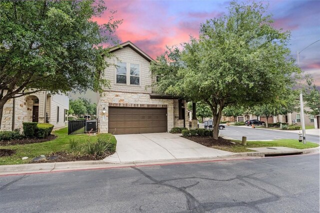 9837 Milla Cir Unit 72, Austin, TX 78748 - view of front facade featuring an attached garage, driveway, and stone siding