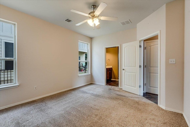 9837 Milla Cir Unit 72, Austin, TX 78748 - unfurnished bedroom featuring carpet floors, baseboards, and connected bathroom