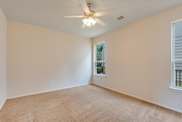 9837 Milla Cir Unit 72, Austin, TX 78748 - spare room featuring light carpet, baseboards, and ceiling fan