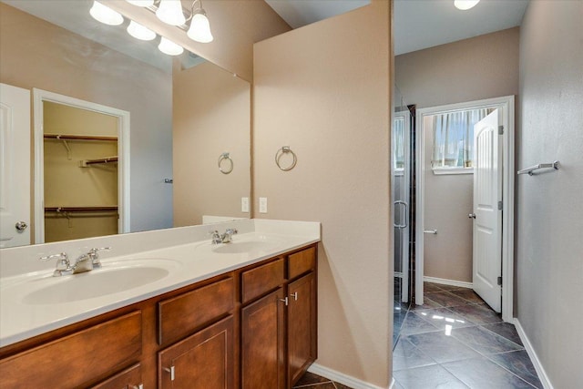 9837 Milla Cir Unit 72, Austin, TX 78748 - full bath featuring double vanity, a stall shower, baseboards, and a walk in closet