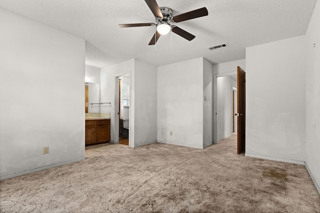 6509 Wagon Wheel Dr, Killeen, TX 76542 - unfurnished bedroom with light carpet, a textured ceiling, ensuite bath, baseboards, and ceiling fan