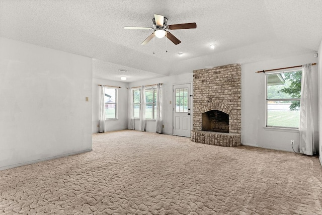 6509 Wagon Wheel Dr, Killeen, TX 76542 - unfurnished living room featuring a textured ceiling, healthy amount of natural light, a ceiling fan, carpet, and vaulted ceiling