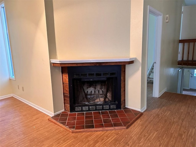 899 Hillyer St Unit 901, San Marcos, TX 78666 - detailed view of wood finished floors, a tiled fireplace, and baseboards