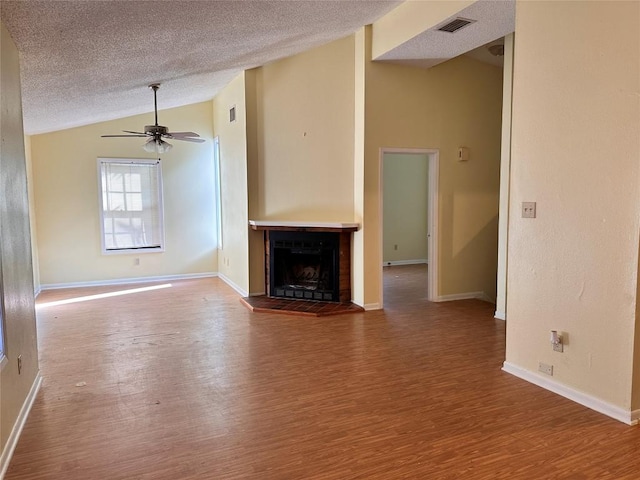 899 Hillyer St Unit 901, San Marcos, TX 78666 - unfurnished living room with lofted ceiling, wood finished floors, a textured ceiling, a ceiling fan, and baseboards