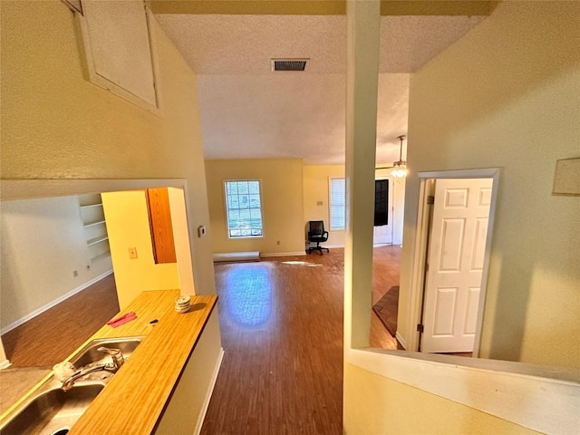 899 Hillyer St Unit 901, San Marcos, TX 78666 - hallway featuring dark wood-style floors, a sink, and baseboards