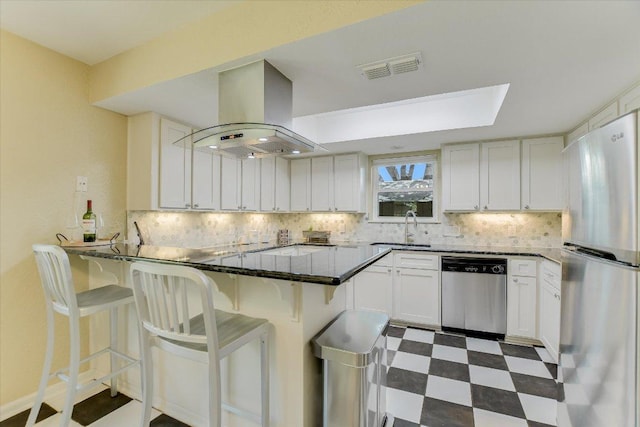 7006 Beckett Rd, Austin, TX 78749 - kitchen featuring stainless steel appliances, range hood, a sink, a kitchen bar, and decorative backsplash