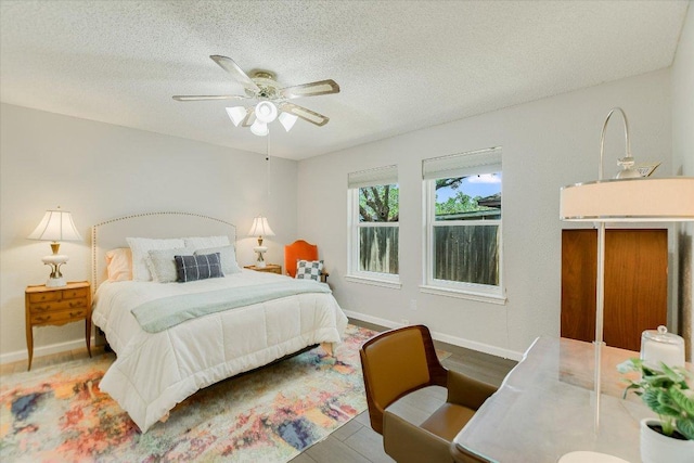 7006 Beckett Rd, Austin, TX 78749 - bedroom with a textured ceiling, baseboards, and a ceiling fan