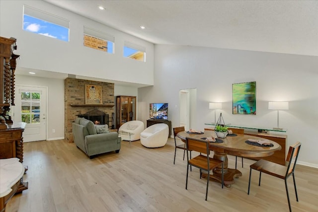 7006 Beckett Rd, Austin, TX 78749 - living area with high vaulted ceiling, light wood-style flooring, a fireplace, baseboards, and recessed lighting