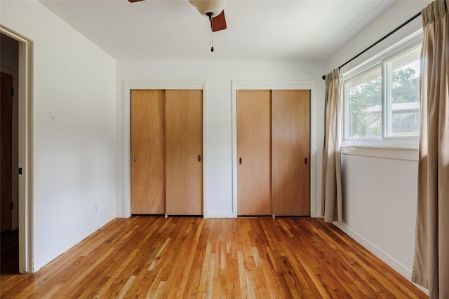2300 Westworth Cir, Austin, TX 78704 - unfurnished bedroom featuring two closets, light wood-style floors, and a ceiling fan