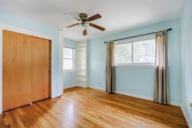 2300 Westworth Cir, Austin, TX 78704 - unfurnished bedroom featuring wood finished floors, multiple windows, and a closet