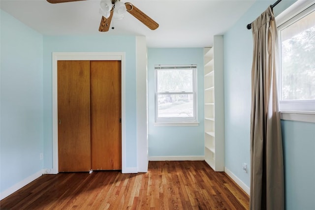 2300 Westworth Cir, Austin, TX 78704 - unfurnished bedroom featuring wood finished floors, baseboards, a closet, and a ceiling fan