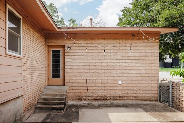 2300 Westworth Cir, Austin, TX 78704 - view of exterior entry with brick siding and a patio area