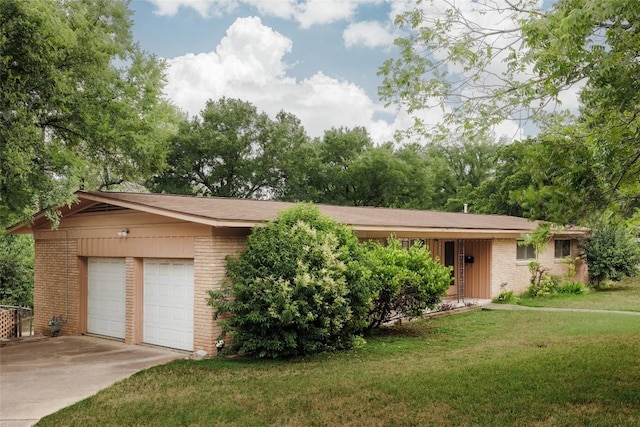 2300 Westworth Cir, Austin, TX 78704 - view of front of home featuring brick siding, a front yard, an attached garage, and driveway