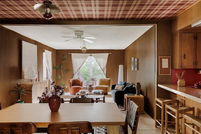 2300 Westworth Cir, Austin, TX 78704 - dining space with ceiling fan, wood walls, and light tile patterned floors