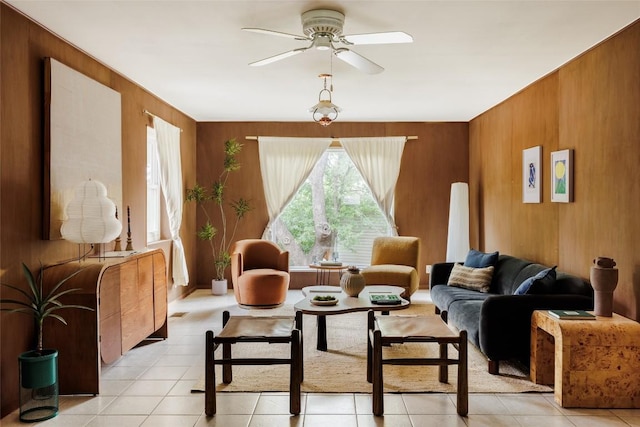 2300 Westworth Cir, Austin, TX 78704 - living area featuring ceiling fan, wooden walls, and light tile patterned floors