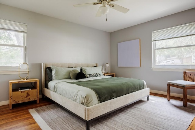 2300 Westworth Cir, Austin, TX 78704 - bedroom with multiple windows, wood finished floors, baseboards, and ceiling fan