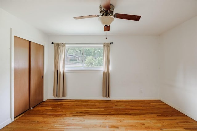 2300 Westworth Cir, Austin, TX 78704 - unfurnished bedroom with light wood-style floors, a closet, a ceiling fan, and baseboards
