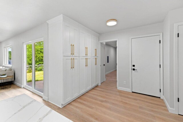 7302 Hartnell Dr, Austin, TX 78723 - foyer entrance with light wood-style flooring and baseboards