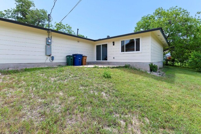 7302 Hartnell Dr, Austin, TX 78723 - rear view of property featuring a lawn