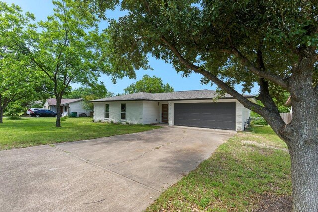 7302 Hartnell Dr, Austin, TX 78723 - ranch-style home featuring an attached garage, concrete driveway, and a front yard
