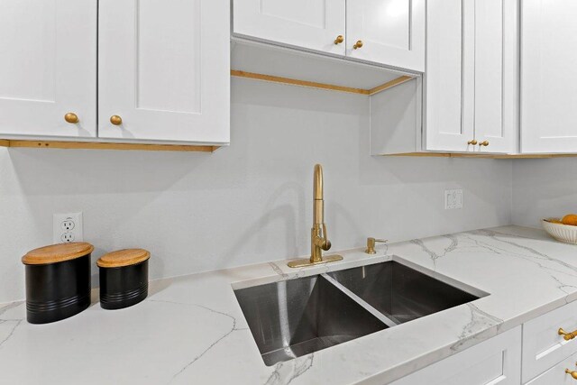 7302 Hartnell Dr, Austin, TX 78723 - kitchen with a sink, white cabinets, and light stone counters