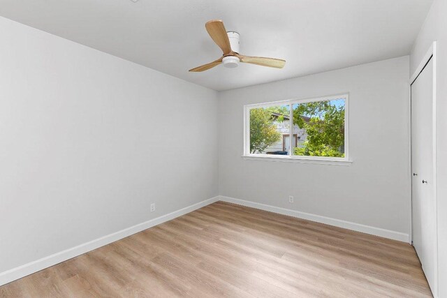 7302 Hartnell Dr, Austin, TX 78723 - unfurnished bedroom with light wood-style floors, baseboards, a closet, and a ceiling fan