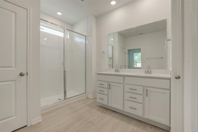 465 Brooks Ranch Dr, Kyle, TX 78640 - full bath with double vanity, a shower stall, wood finished floors, and recessed lighting