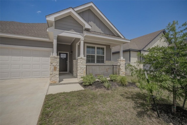 465 Brooks Ranch Dr, Kyle, TX 78640 - craftsman-style house with board and batten siding, stone siding, an attached garage, a shingled roof, and a porch