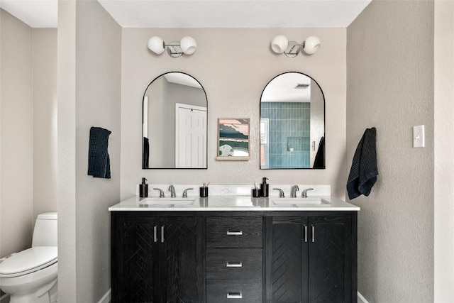 8504 Verona Trl, Austin, TX 78749 - bathroom featuring double vanity and a textured wall