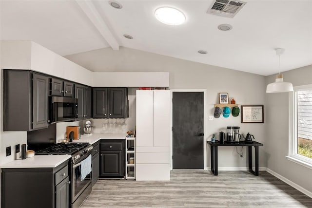 8504 Verona Trl, Austin, TX 78749 - kitchen featuring appliances with stainless steel finishes, light wood-style flooring, light countertops, and pendant lighting