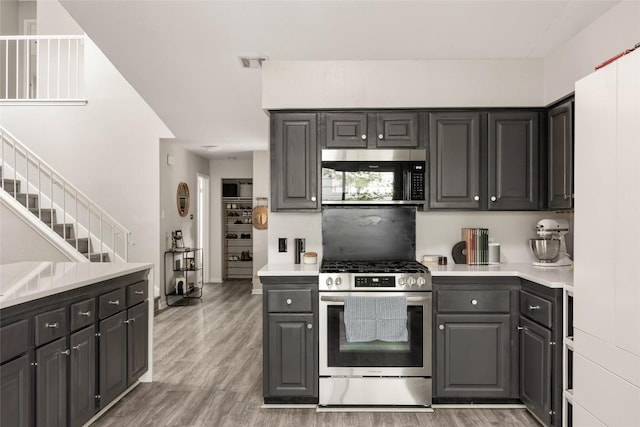 8504 Verona Trl, Austin, TX 78749 - kitchen with stainless steel appliances, light wood-type flooring, light countertops, and gray cabinetry
