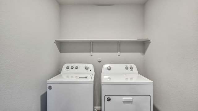 13702 Bothwell Pl, Manor, TX 78653 - laundry room featuring separate washer and dryer and a textured wall