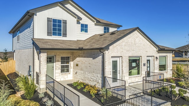 13702 Bothwell Pl, Manor, TX 78653 - view of front of home featuring brick siding, roof with shingles, and board and batten siding