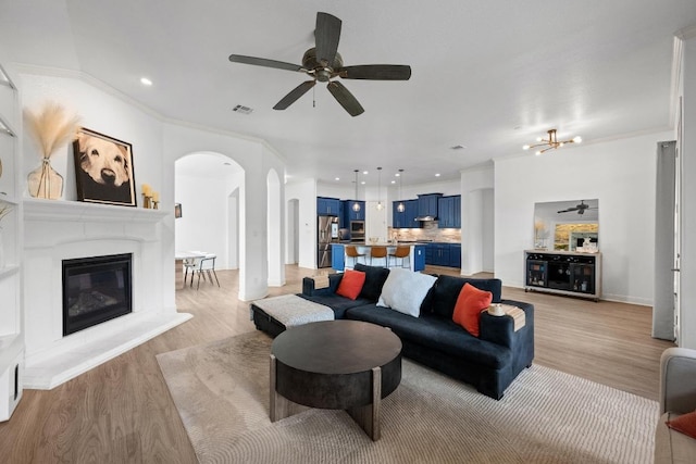 2565 Reunion Blvd, Austin, TX 78737 - living area with arched walkways, a ceiling fan, light wood-style flooring, recessed lighting, and ornamental molding