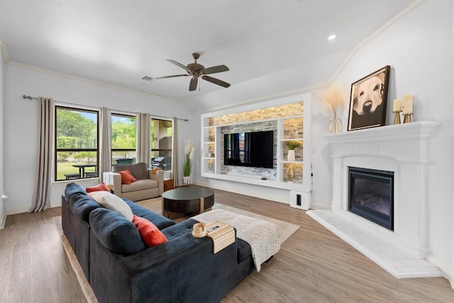 2565 Reunion Blvd, Austin, TX 78737 - living room featuring ceiling fan, ornamental molding, wood finished floors, a glass covered fireplace, and lofted ceiling