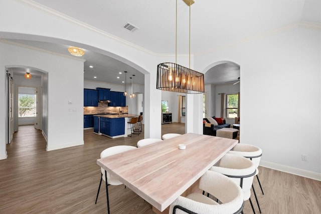 2565 Reunion Blvd, Austin, TX 78737 - dining room with arched walkways, ornamental molding, wood finished floors, baseboards, and a ceiling fan