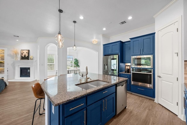 2565 Reunion Blvd, Austin, TX 78737 - kitchen featuring stainless steel appliances, blue cabinets, a sink, ornamental molding, and recessed lighting