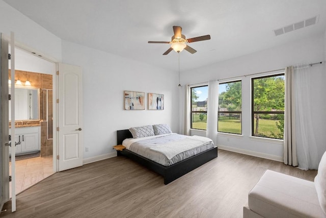2565 Reunion Blvd, Austin, TX 78737 - bedroom with baseboards, light wood-style flooring, a ceiling fan, and ensuite bath