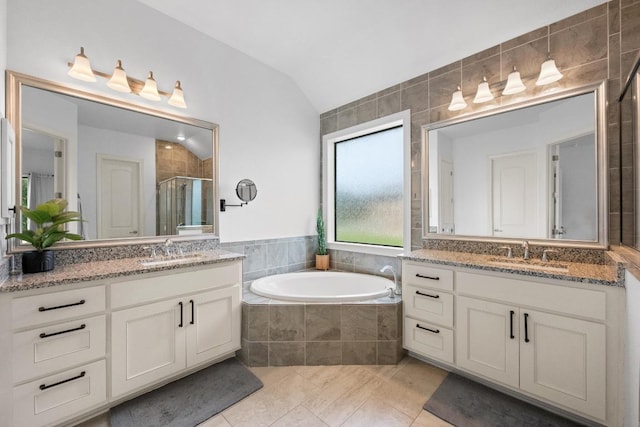 2565 Reunion Blvd, Austin, TX 78737 - bathroom featuring lofted ceiling, two vanities, a shower stall, a bath, and tile patterned floors