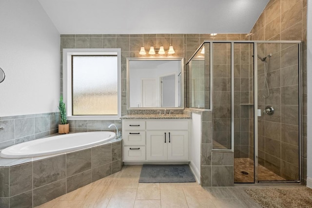 2565 Reunion Blvd, Austin, TX 78737 - full bath featuring vanity, a bath, a stall shower, lofted ceiling, and tile patterned flooring