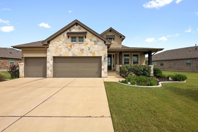 2565 Reunion Blvd, Austin, TX 78737 - view of front of home featuring stone siding, a front lawn, driveway, a garage, and a porch