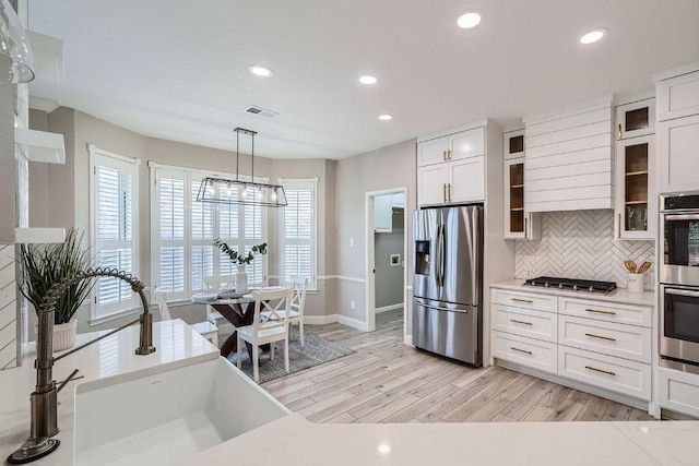 1237 Fall Creek Loop, Cedar Park, TX 78613 - kitchen with appliances with stainless steel finishes, light wood-style flooring, backsplash, recessed lighting, and baseboards