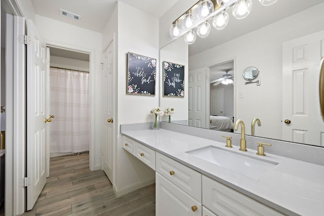 1237 Fall Creek Loop, Cedar Park, TX 78613 - ensuite bathroom featuring vanity, wood finished floors, and ceiling fan