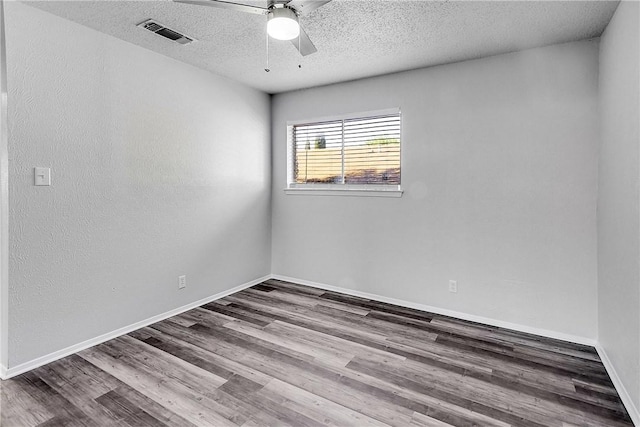 9406 Quail Meadow Dr, Austin, TX 78758 - empty room featuring wood finished floors, a ceiling fan, a textured ceiling, and baseboards