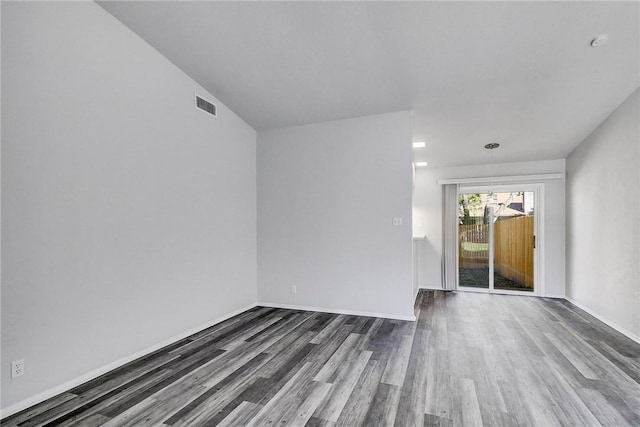9406 Quail Meadow Dr, Austin, TX 78758 - unfurnished room featuring dark wood-style flooring, baseboards, and a smoke detector