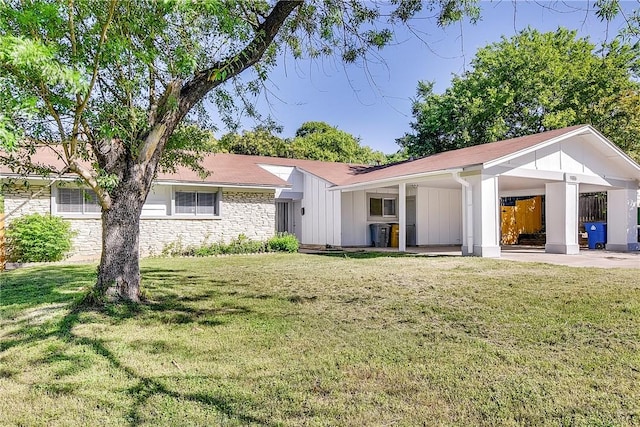 9406 Quail Meadow Dr, Austin, TX 78758 - view of front of house with an attached carport, a front lawn, and stone siding