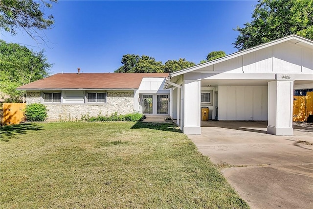 9406 Quail Meadow Dr, Austin, TX 78758 - view of front of house featuring concrete driveway, stone siding, and a carport