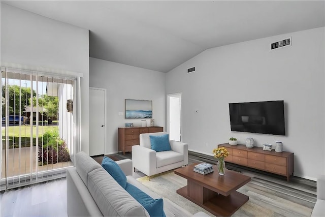 9406 Quail Meadow Dr, Austin, TX 78758 - living room featuring wood finished floors, high vaulted ceiling, and baseboards