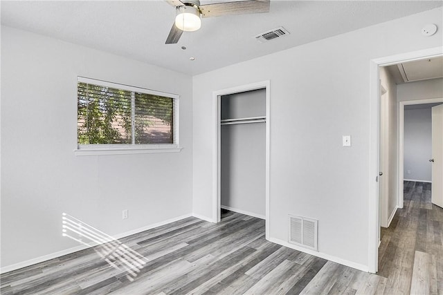 9406 Quail Meadow Dr, Austin, TX 78758 - unfurnished bedroom with attic access, wood finished floors, a closet, and baseboards