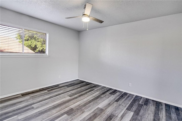 9406 Quail Meadow Dr, Austin, TX 78758 - empty room featuring dark wood-style flooring, a ceiling fan, a textured ceiling, and baseboards